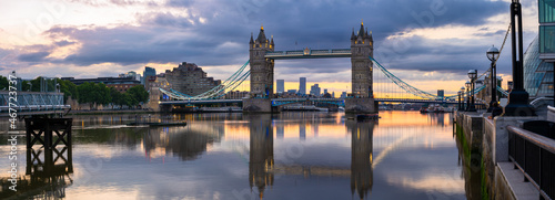 Tower Bridge at colourful sunrise with reflection in London. England