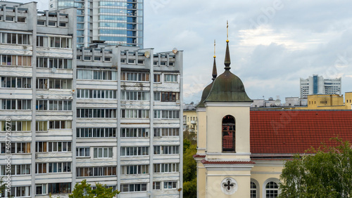Old church and Modern resedential building. A combination of history and modernity. photo