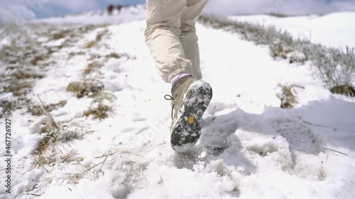 young girl climbs a mountain in the Carpathians in winter