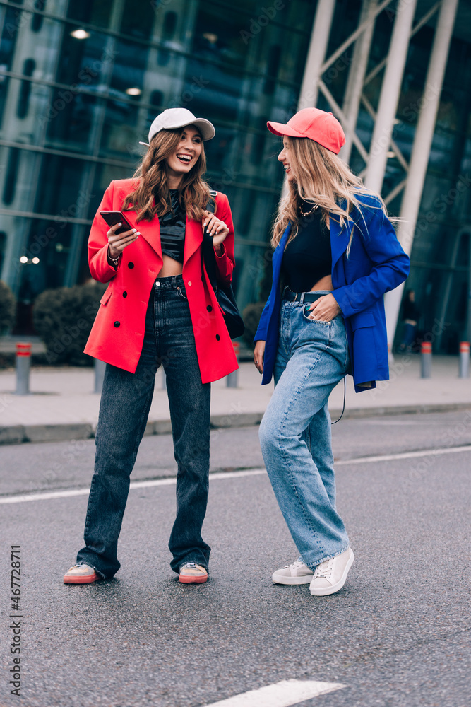 Naklejka premium Two happy girls walking near airport. Air travel, summer holiday