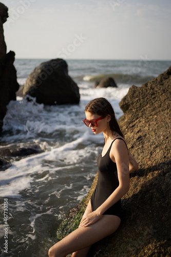 woman in swimsuit sunglasses ocean rocks posing © VICHIZH