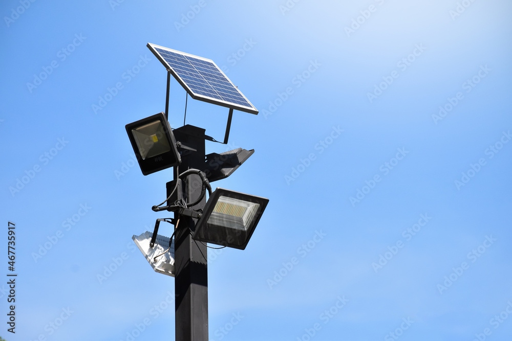 Photovoltaic panel which installed on the top of the metal pole to store and use the sun power around the public park at night. Photovoltaic panel which installed on the top of the metal pole to store and use the sun power around the public park at night.