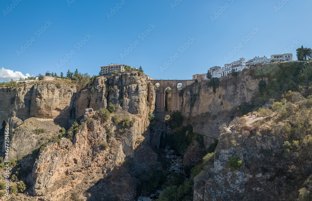 Aerial view at the iconic New Bridge above the gauge, natural geological phenomenon, erosion cliffs around the Ronda city, touristic travel destination, El Tajo Gorge