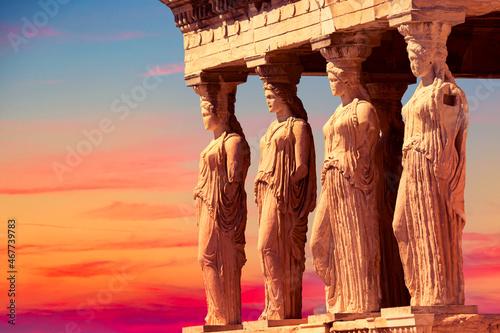 Detail of Caryatid Porch on the Acropolis uring colorful sunset in Athens, Greece. Ancient Erechtheion or Erechtheum temple. World famous landmark at the Acropolis Hill.