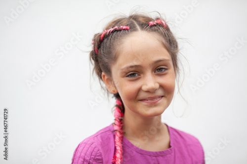 Emotional portrait of a 9-year-old girl with red pigtails