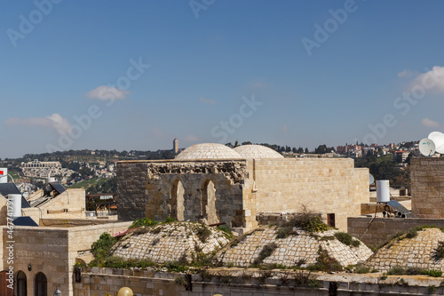 view of the walls and roofs of buildings in the old city of Jerusalem