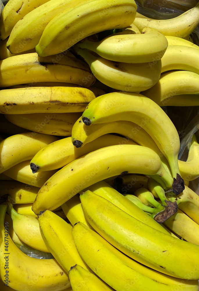 Yellow ripe bananas in the grocery store, healthy tropical fruit