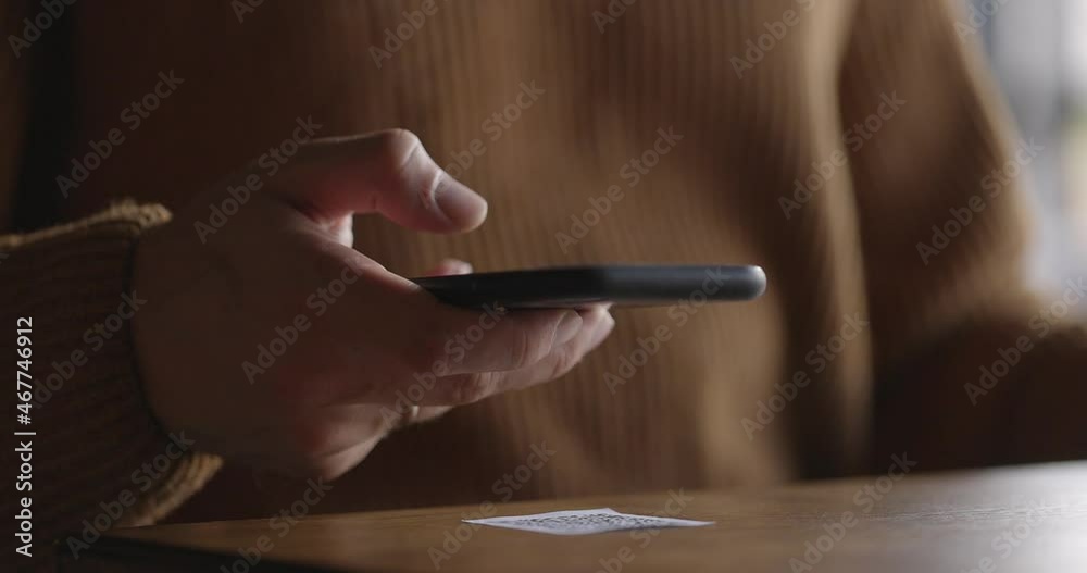 Close-up of smartphone in male hands tapping on screen. Man scanning QR code on table in restaurant or cafe. Online menu for clients. Convenience, contactless concept. Close-up of smartphone in male hands tapping on screen. Man scanning QR code on table in restaurant or cafe. Online menu for clients. Convenience, contactless concept.