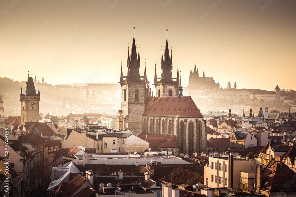 Prague towers of Old Town with Tyn church aerial view and Prague Castle, sunset view, golden light, travel to Prague