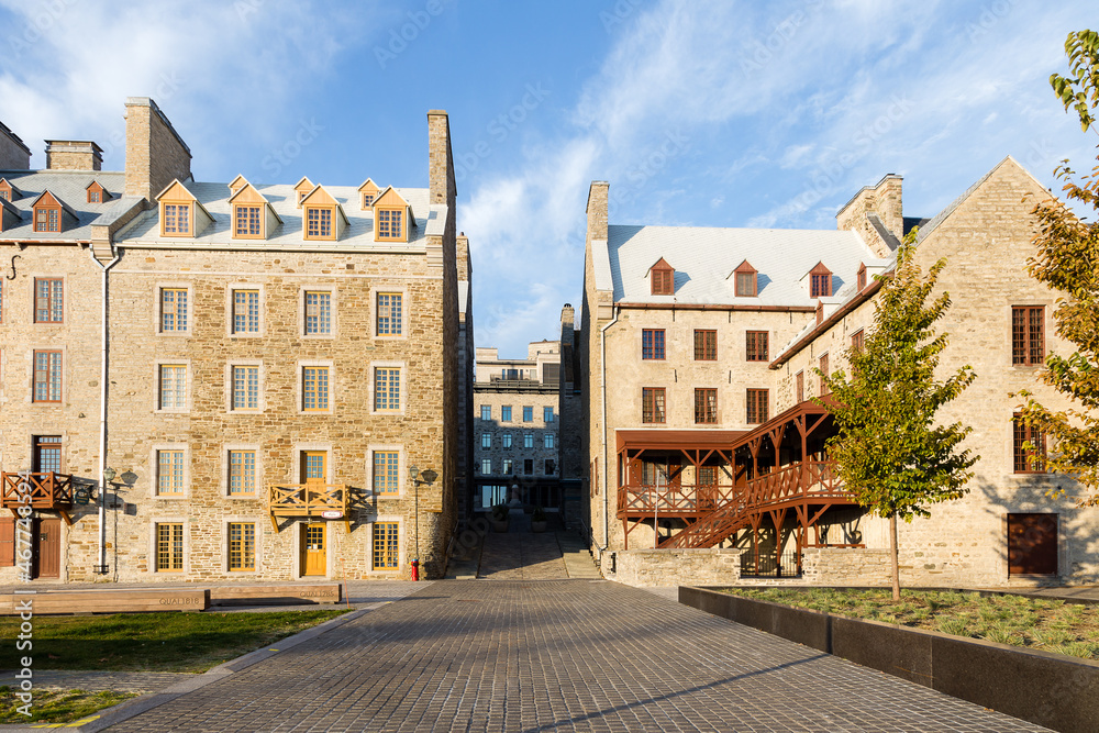 Historic buildings on Place de Paris in the Petit-Champlain sector seen during a fall golden hour morning, Quebec City, Quebec, Canada