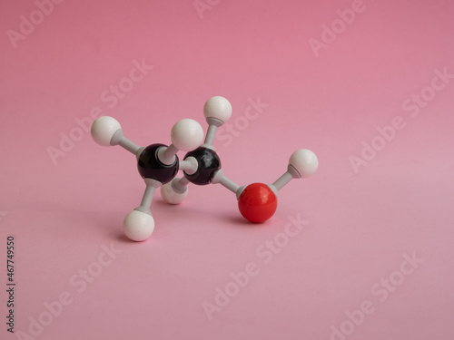 Photo of a molecular atom model isolated on a pink background.