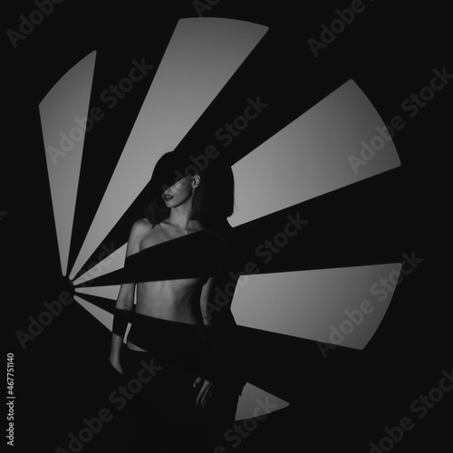 Beautiful girl posing in a photo studio. Shooting with gobo masks