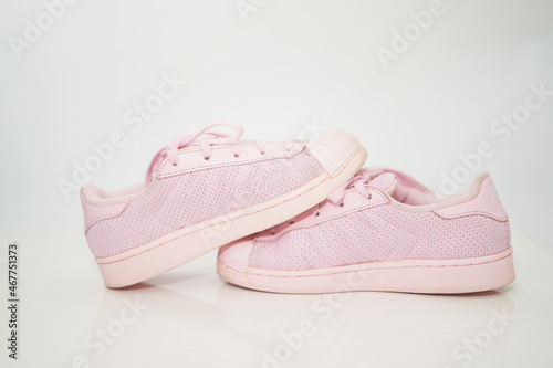 pink sneakers shoes with shoelace side view on floor soft focus