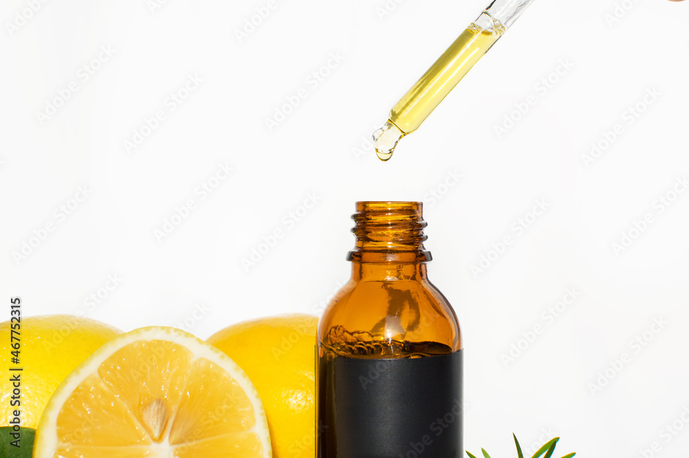 The concept of natural care cosmetics
with a bottle of essential oil and serum on a white background and with lemon and green leaves. Flat composition with cosmetic products with place for text. The concept of natural care cosmetics
with a bottle of essential oil and serum on a white background and with lemon and green leaves. Flat composition with cosmetic products with place for text.