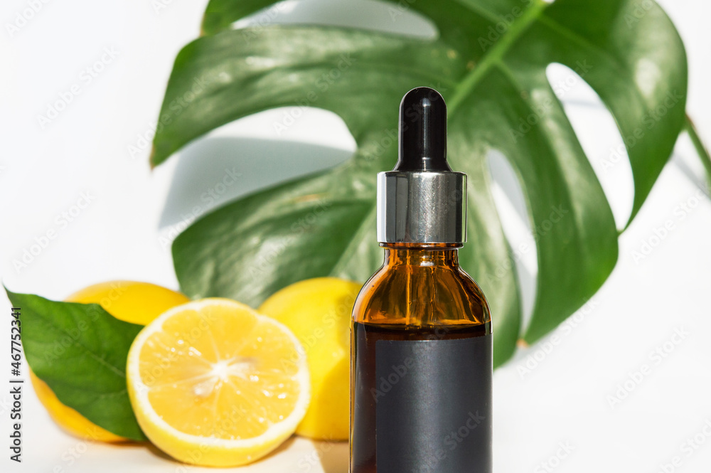 The concept of natural care cosmetics
with a bottle of essential oil and serum on a white background and with lemon and green leaves. Flat composition with cosmetic products with place for text. The concept of natural care cosmetics
with a bottle of essential oil and serum on a white background and with lemon and green leaves. Flat composition with cosmetic products with place for text.