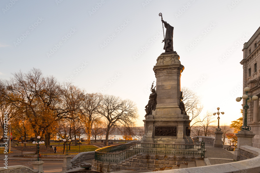 The 1908 Monseigneur-De Laval monument in front of the old post office seen during a golden hour fall morning