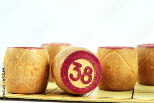 Family board game Lotto. Wooden barrels loto numbered 38 on a white background photo