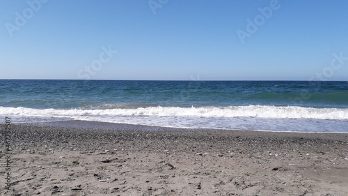Heavy waves are ending their run on the shore.