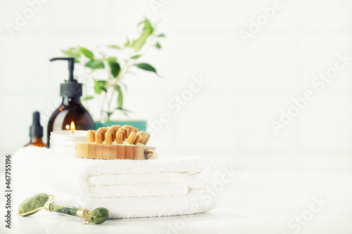 SPA and Bathroom accessories on white bathroom countertop against tile wall - Lymph drainage and lymph massage