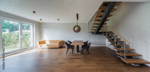 Modern interior of private house. Living room with table and chairs.