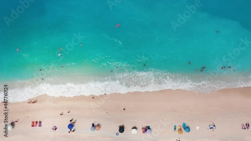 Aerial view of people sunbathing at the exotic turquoise sea of Myrtos beach at Kefalonia island, Greece photo