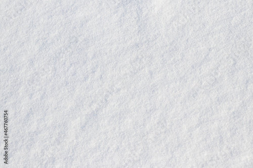 Uniform snow cover. Snow texture on a flat plot of land © Volodymyr