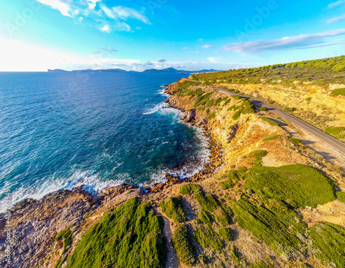 Aerial view of rocks and blue sea in Alghero southern coas