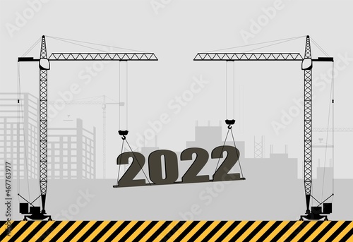 New Year card. Tower construction cranes are lifting the New Year 2022 numbers.
