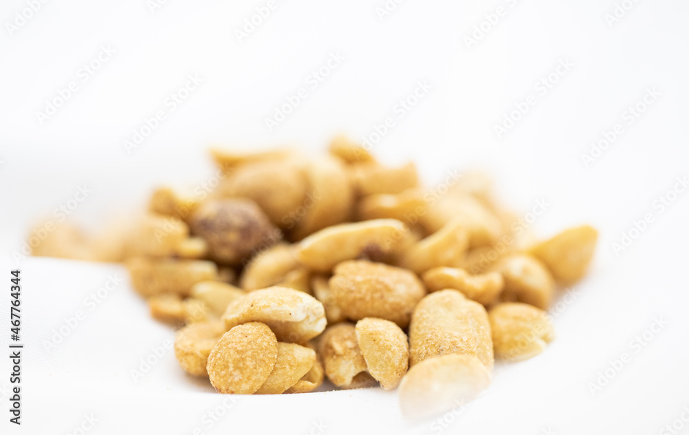 Close up of salted peanuts in white background. Close up of salted peanuts in white background.