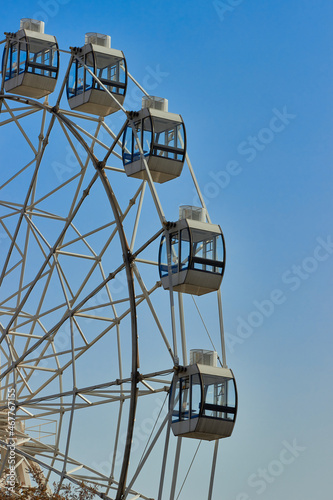 Ferris wheel against the sky. Ferris wheel in the sky. The cab for the Ferris wheel. City entertainment. © AlexValya
