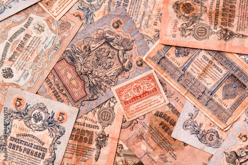 Chaotically scattered old worn ruble banknotes of royal russia. Top view