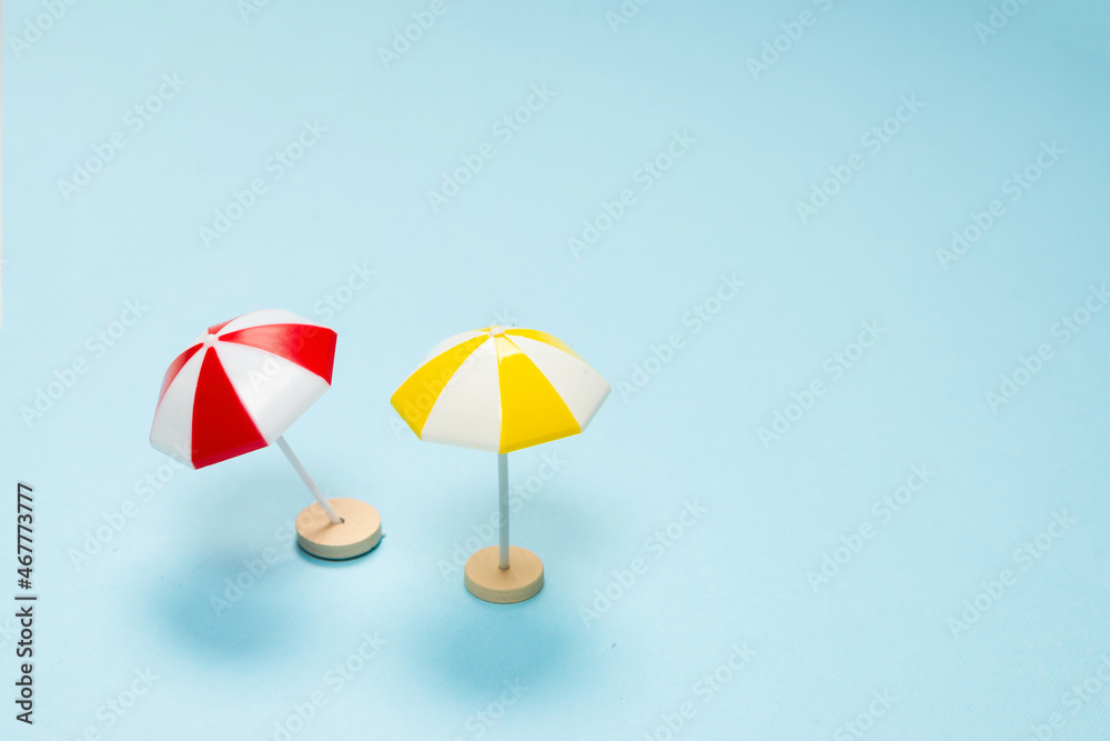 Yellow and red umbrella on a blue background. Yellow and red umbrella on a blue background.