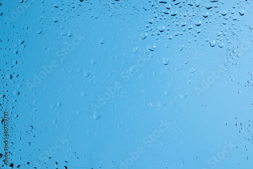 Blue backgrond with water drops. Wet glass.