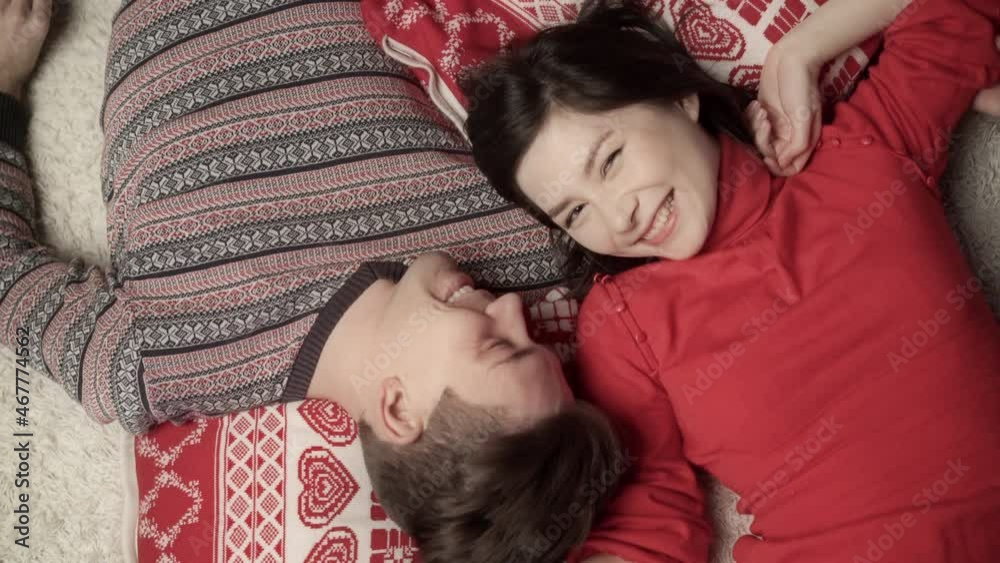 Cute couple in love enjoying xmas and lying head to head. Top view. Relationship, family, christmas, new year, holiday concet.