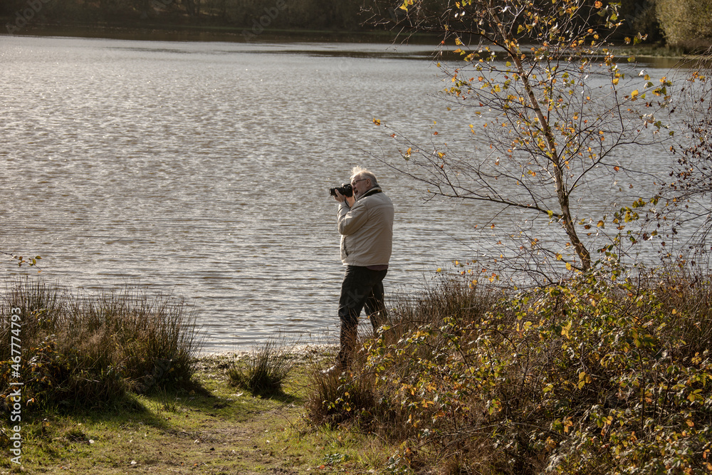 Landscape nature photo. Old photographer filming. Make perfect frame. Manual settings. Pension hobby. Experienced photographer. Old man shoot nature. Cameraman retirement. Professional photographer Landscape nature photo. Old photographer filming. Make perfect frame. Manual settings. Pension hobby. Experienced photographer. Old man shoot nature. Cameraman retirement. Professional photographer