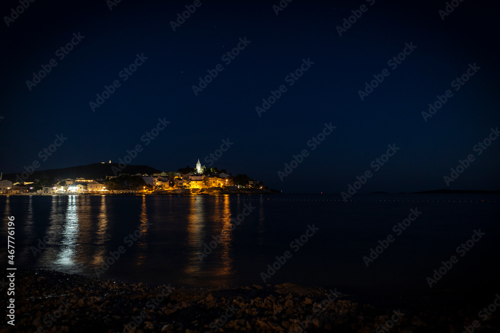 Beautiful night panorama of wonderful dalmatian town of Primosten and its old houses and church on the small island