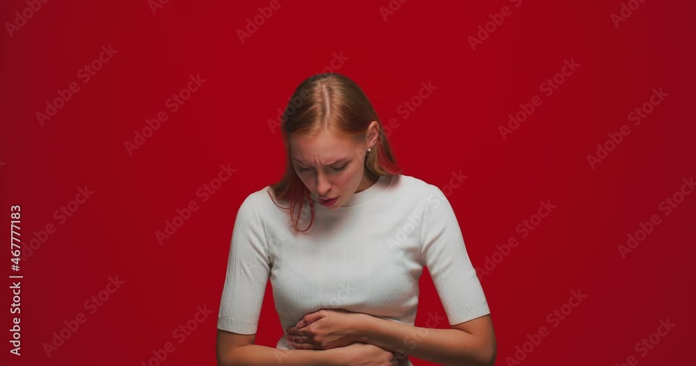Sick young girl suffering stomach ache, abdominal cramp, periods spasm, irritable bowel syndrome of diet, indigestion