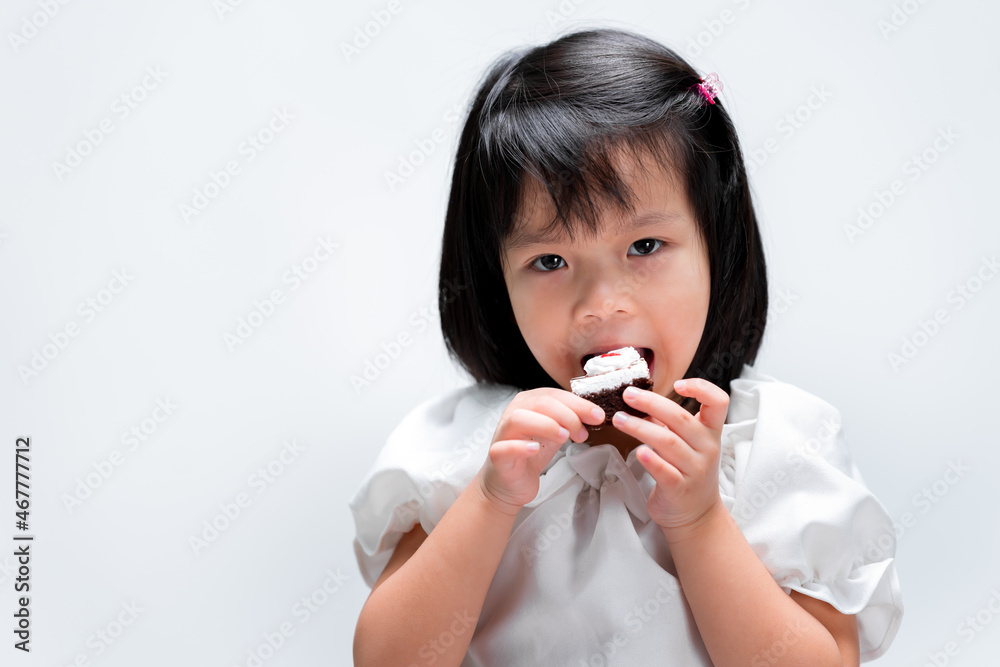 Happy girl biting chocolate cake tasty. Yummy bakery for kid. Happy girl biting chocolate cake tasty. Yummy bakery for kid.
