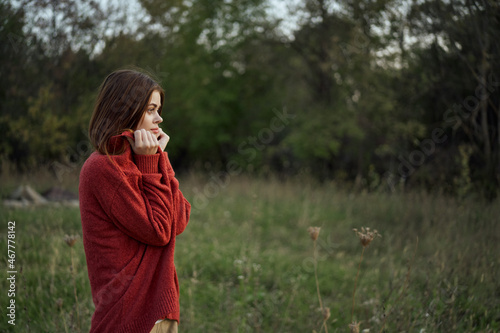 woman outdoors in a red sweater cool nature