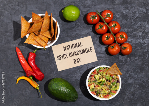 Fototapeta Naklejka Na Ścianę i Meble -  The ingredients for making Spicy Guacamole are avocado, red onion, tomato, chili, lime, cilantro, and garlic. National Guacamole Day.