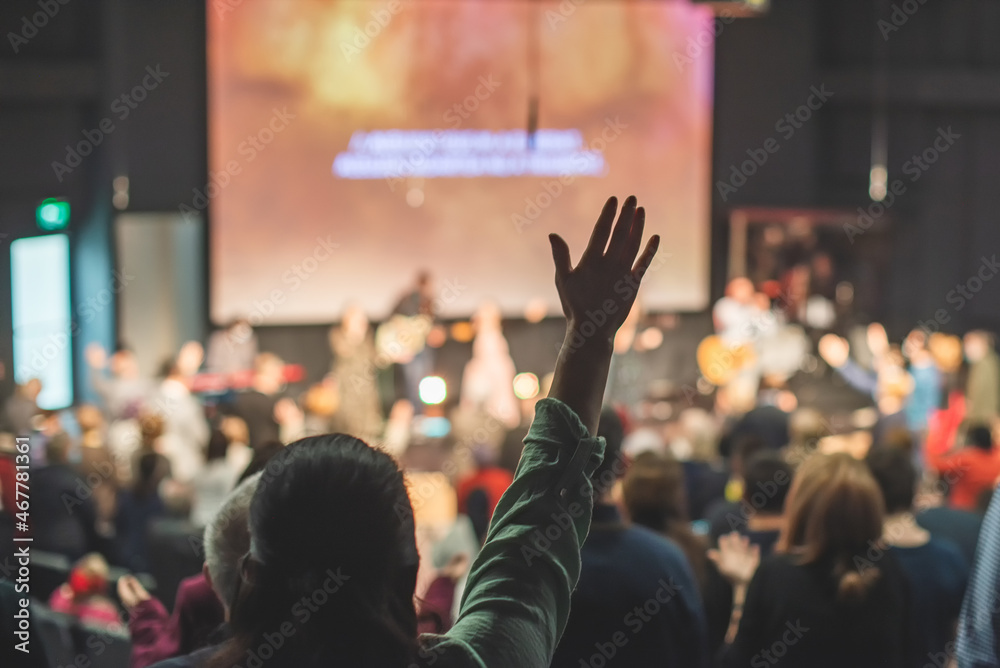Hands in the air of people who praise God at church service - obrazy, fototapety, plakaty 