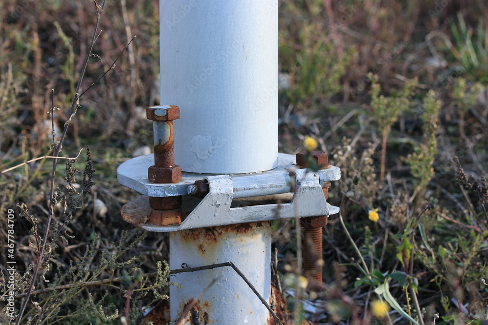 Rusty bolts and nuts on the hinge of the metal mast Rusty bolts and nuts on the hinge of the metal mast