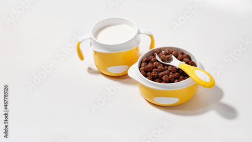 Children s breakfast in a bowl on a white background. Baby food equipment