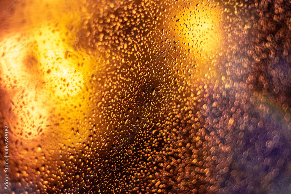 Drops on the glass with lights in the form of bokeh