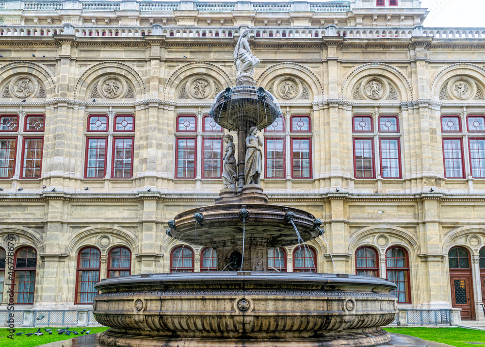 Beautiful stone fountain at the facade of the Vienna Opera House