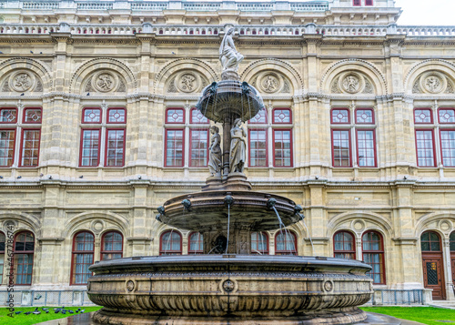 Beautiful stone fountain at the facade of the Vienna Opera House