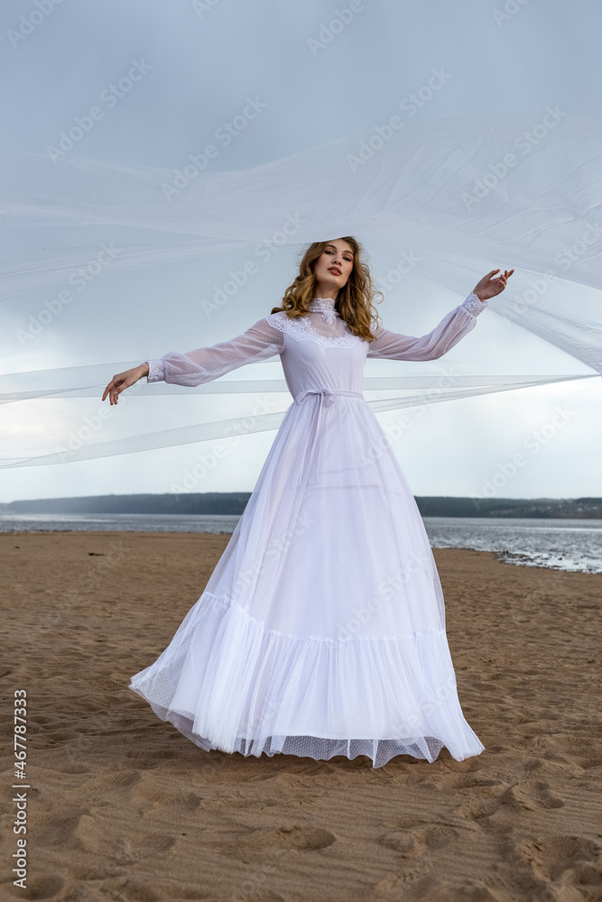 Happy young girl in a white dress on the sandy shore. Thunder Sky Happy young girl in a white dress on the sandy shore. Thunder Sky