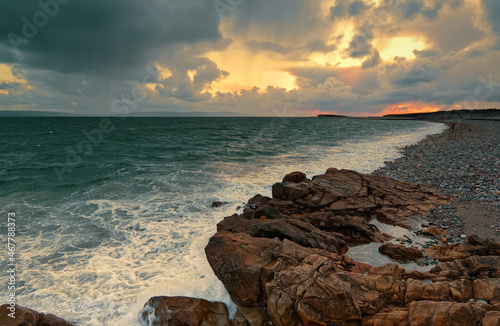 Beautiful seascape sunset scenery of rocky coast at Salthill beach in Galway city, Ireland 