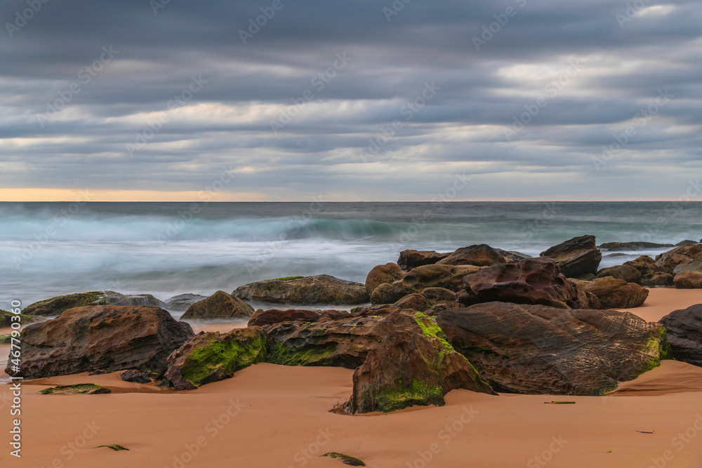 Low cloud covered sunrise seascape with rocks