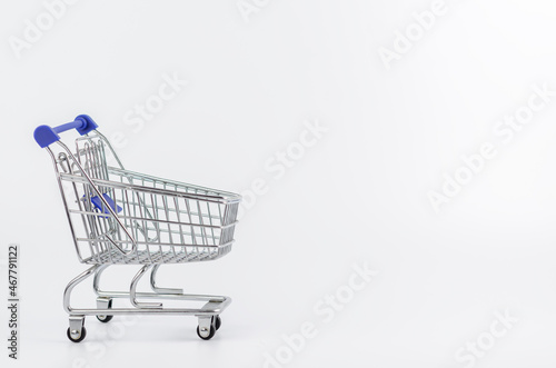 Grocery cart on wheels on a white background. Shopping, sales. Space for text.